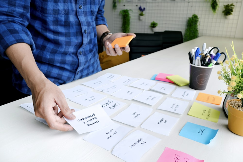 person holding white printer paper