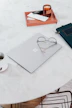 Minimalist workspace with a clean notebook, coffee cup, and modern glasses.