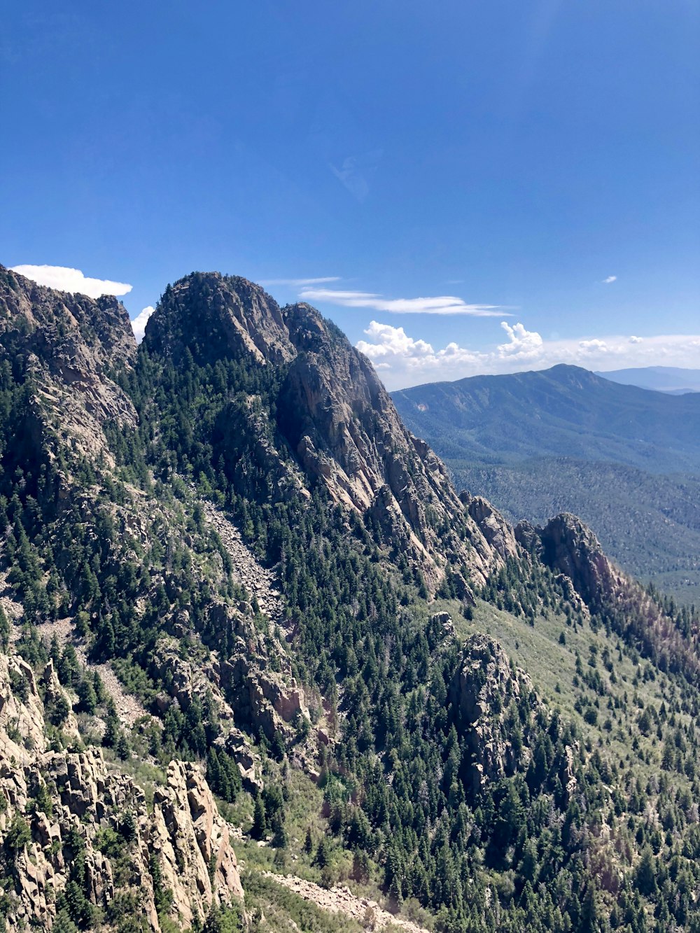 green and brown mountains under blue sky during daytime