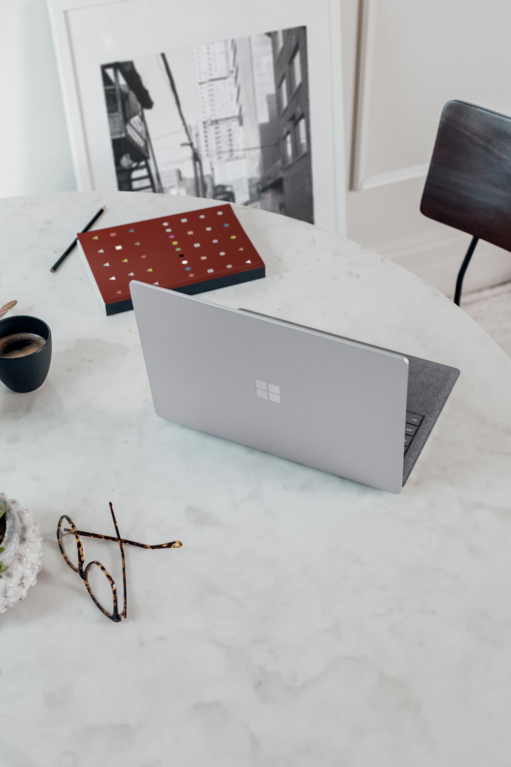 silver microsoft surface laptop computer on white table