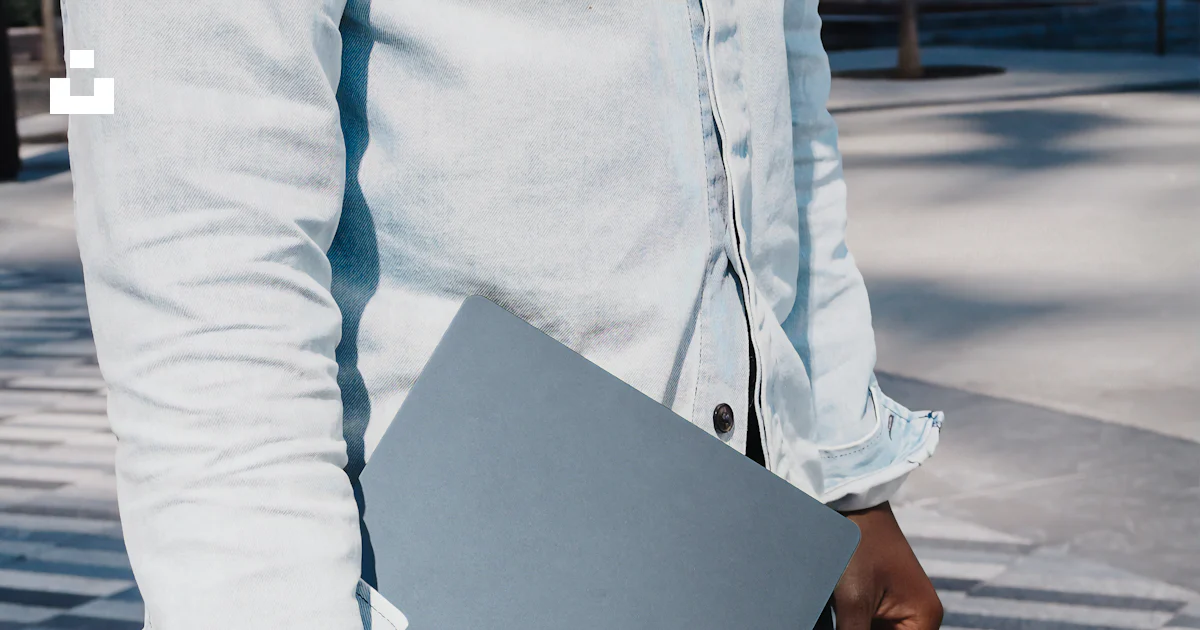 Man in dress shirt holding blue microsoft surface laptop computer photo ...