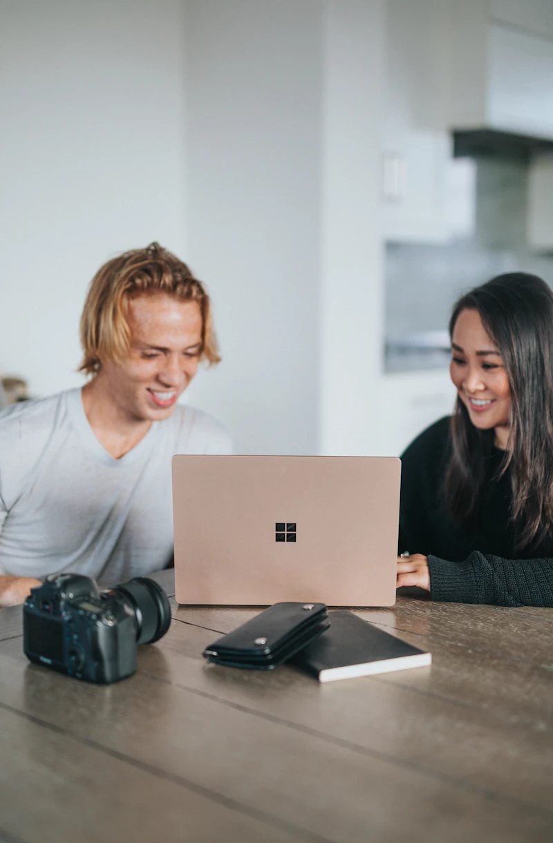 Two people working together at a laptop