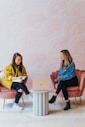 3 women sitting on chair