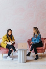 3 women sitting on chair