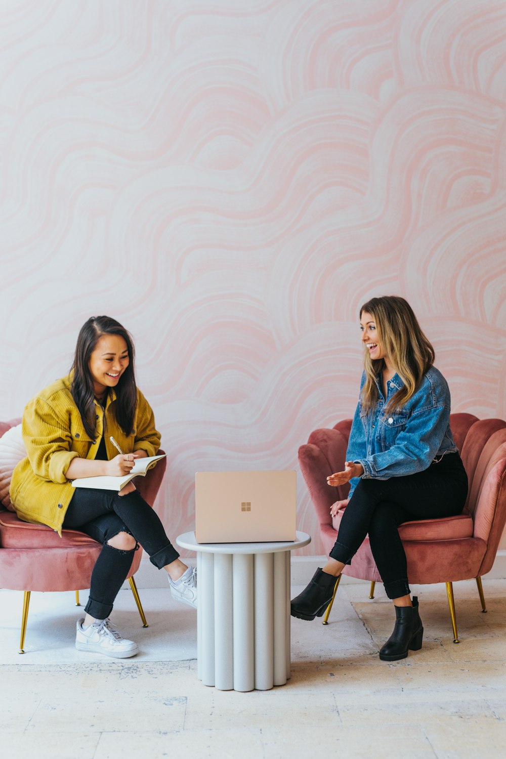 3 women sitting on chair