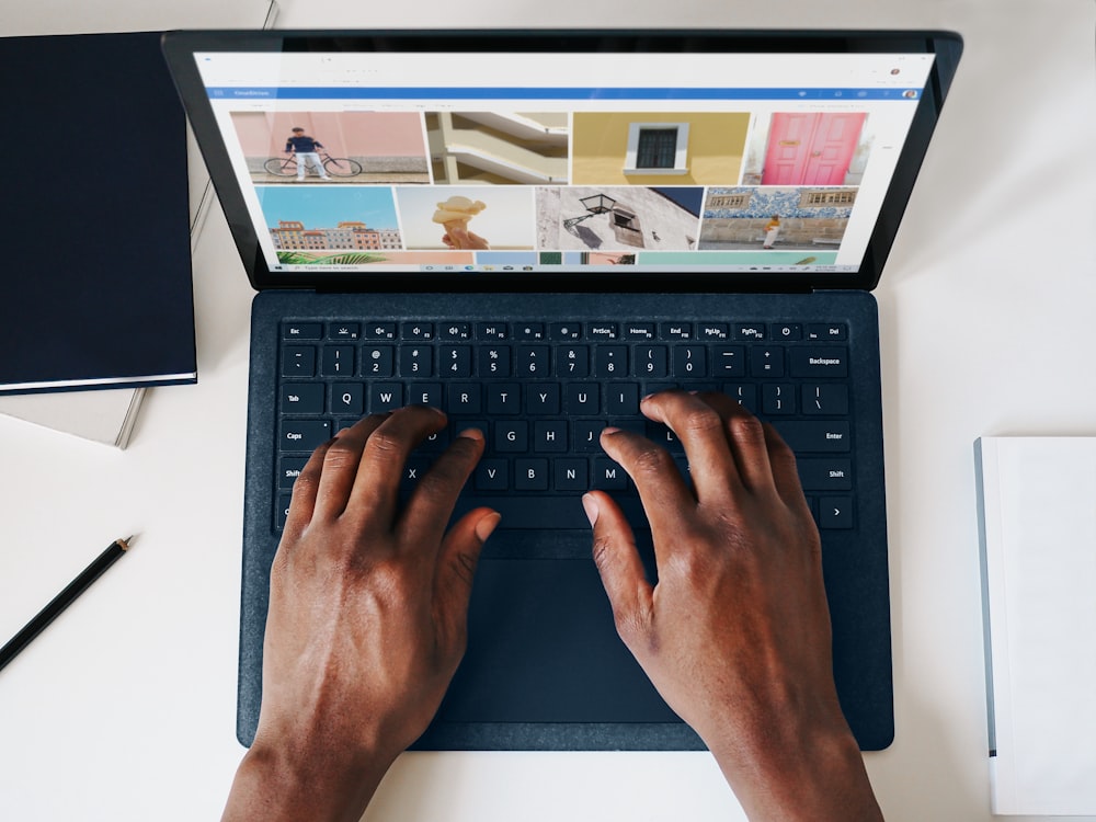 person using black and silver laptop computer