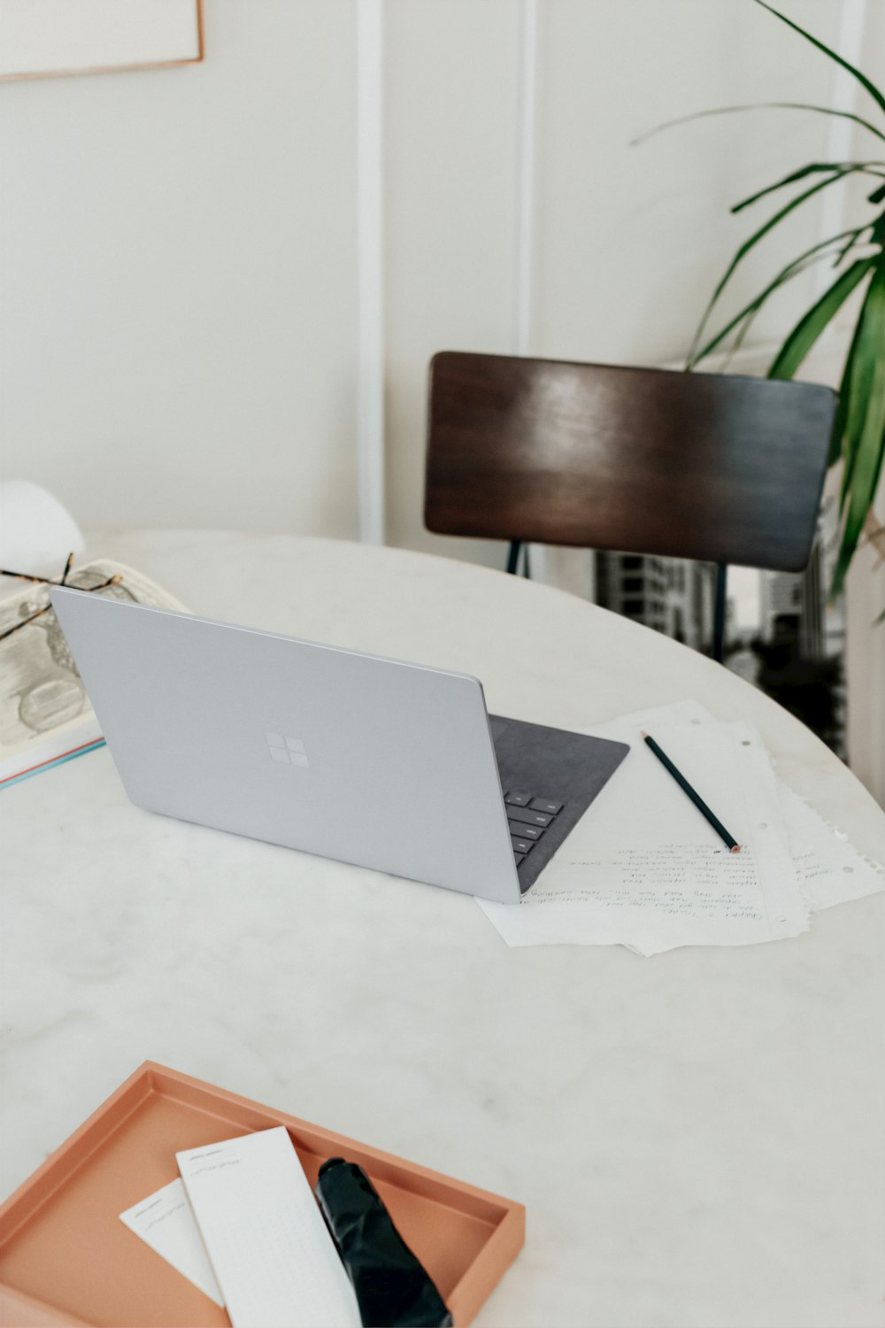 silver microsoft surface laptop on white table