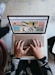 person using microsoft surface laptop on lap with two other people