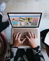 person using microsoft surface laptop on lap with two other people