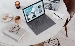 black laptop computer on round table on a Surface Laptop 