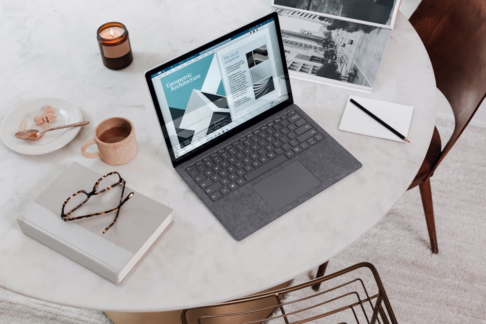 black laptop computer on round table on a Surface Laptop 