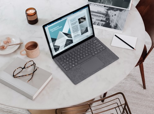 black laptop computer on round table on a Surface Laptop 