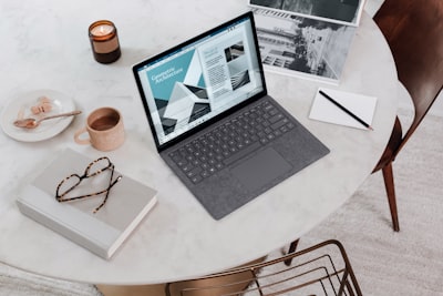 black laptop computer on round table on a surface laptop laptop teams background