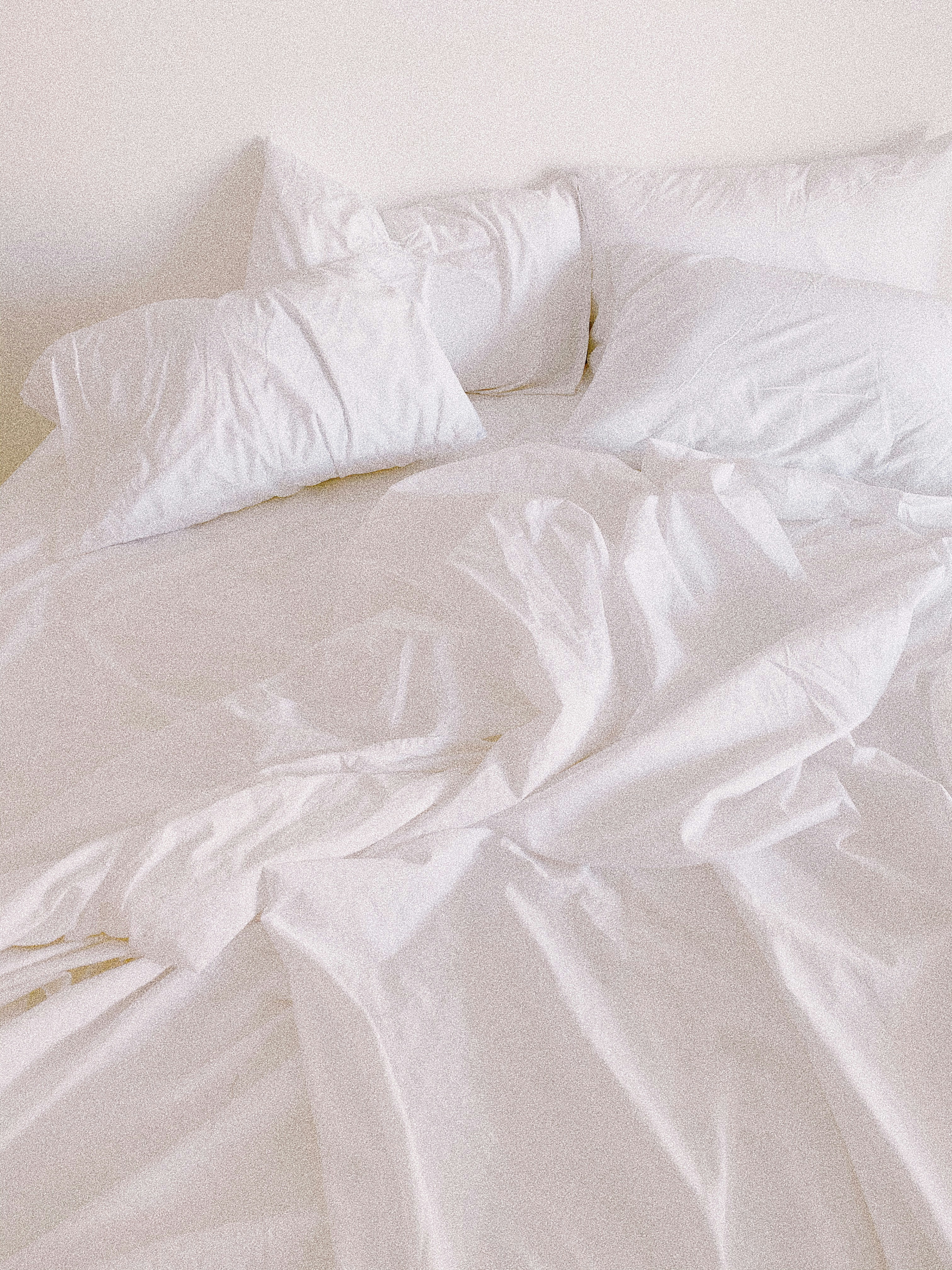 white bed pillow on bed