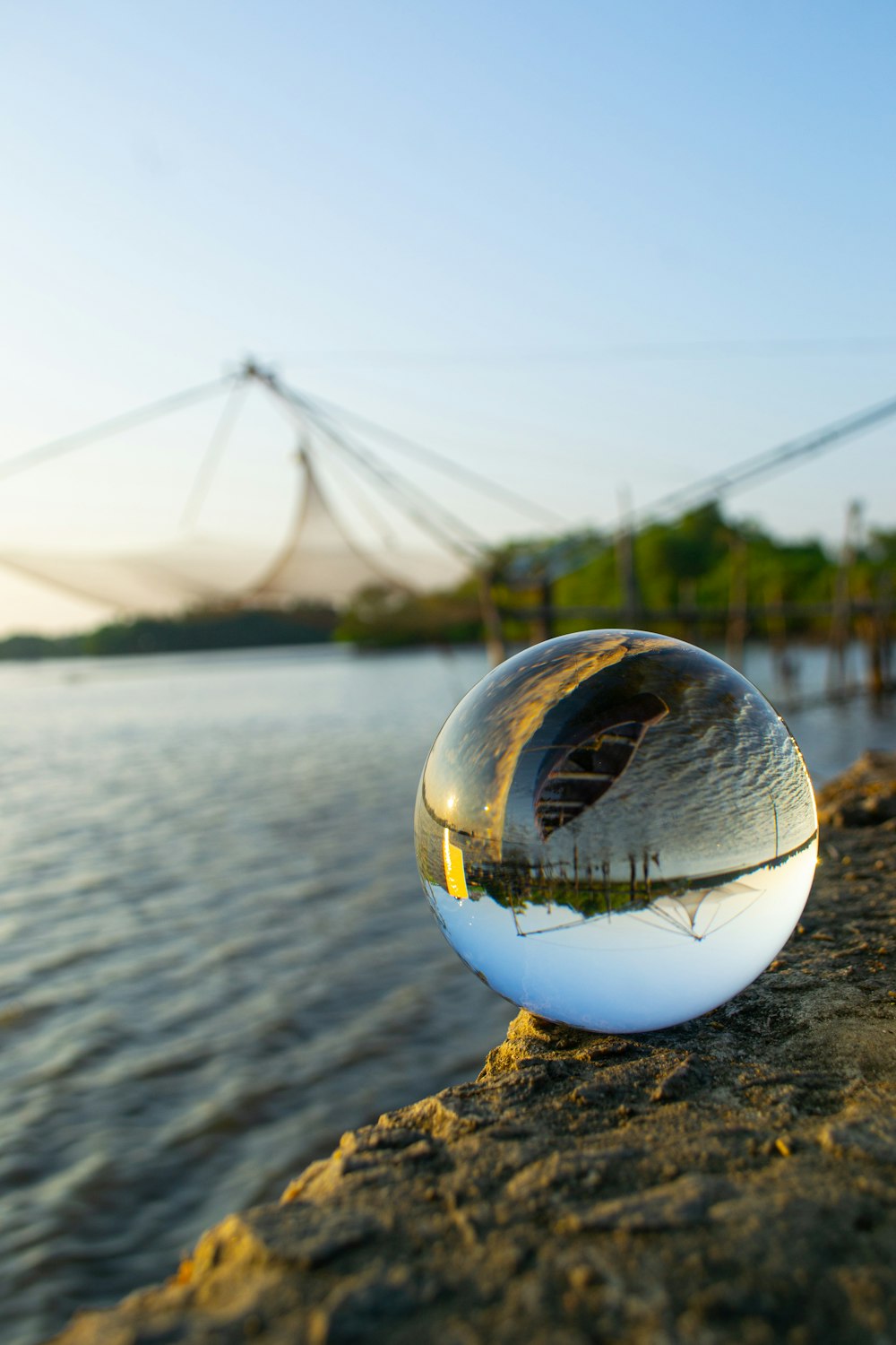 clear glass ball on body of water during daytime