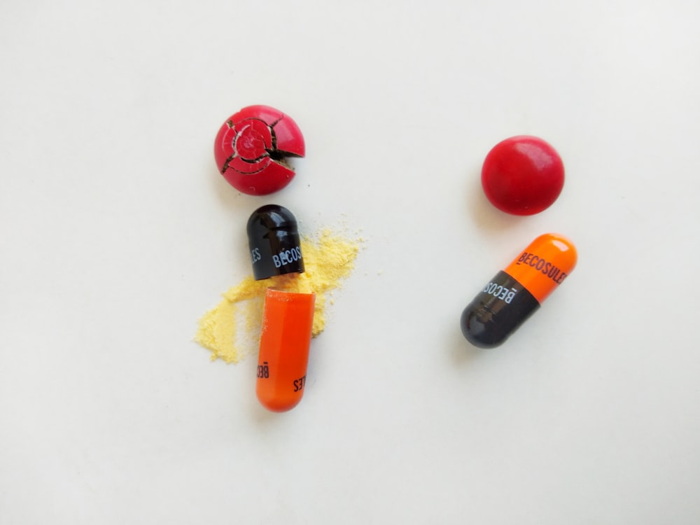 red yellow and black medicine capsules
