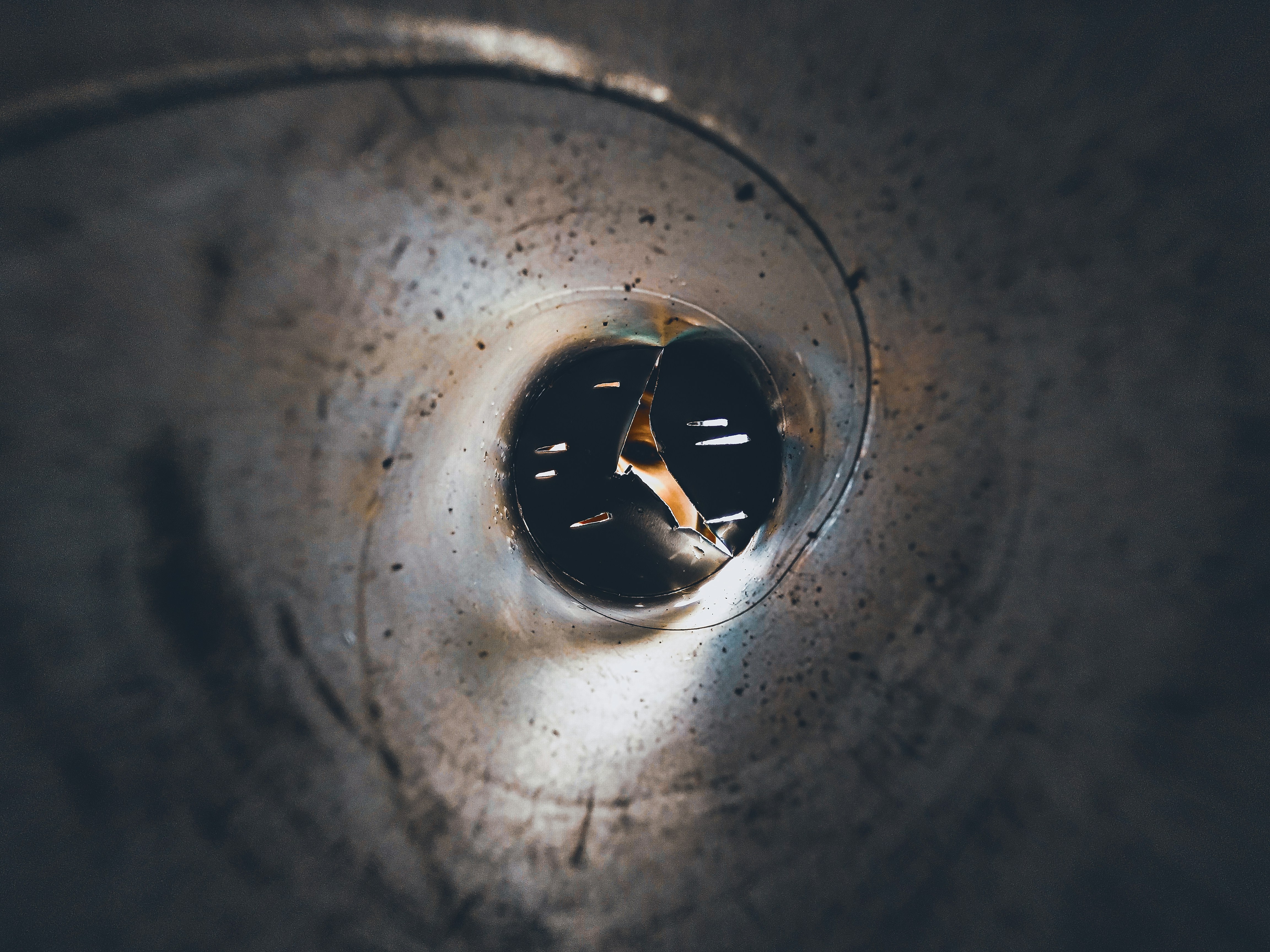 Close-up of a plumber carefully guiding a camera through a narrow pipe.