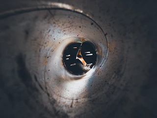 Close-up of a specialized inspection camera navigating inside a pipe.