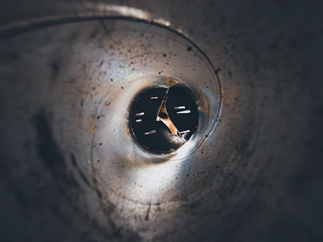 Close-up of a specialized inspection camera navigating inside a pipe.