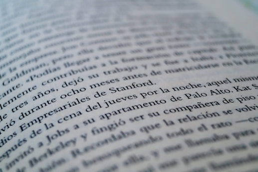 A close-up view of a page from a book with text in a language similar to Spanish. The focus is on specific lines that mention locations like Stanford and Palo Alto, while the rest of the text gradually blurs towards the edges.
