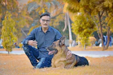 A man sitting on the ground with a dog