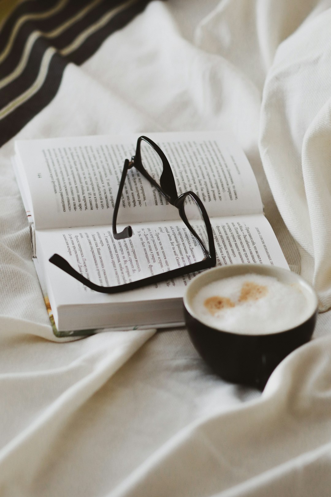 black framed eyeglasses on white book page