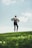 woman in black long sleeve shirt and black pants standing on green grass field during daytime