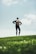 woman in black long sleeve shirt and black pants standing on green grass field during daytime