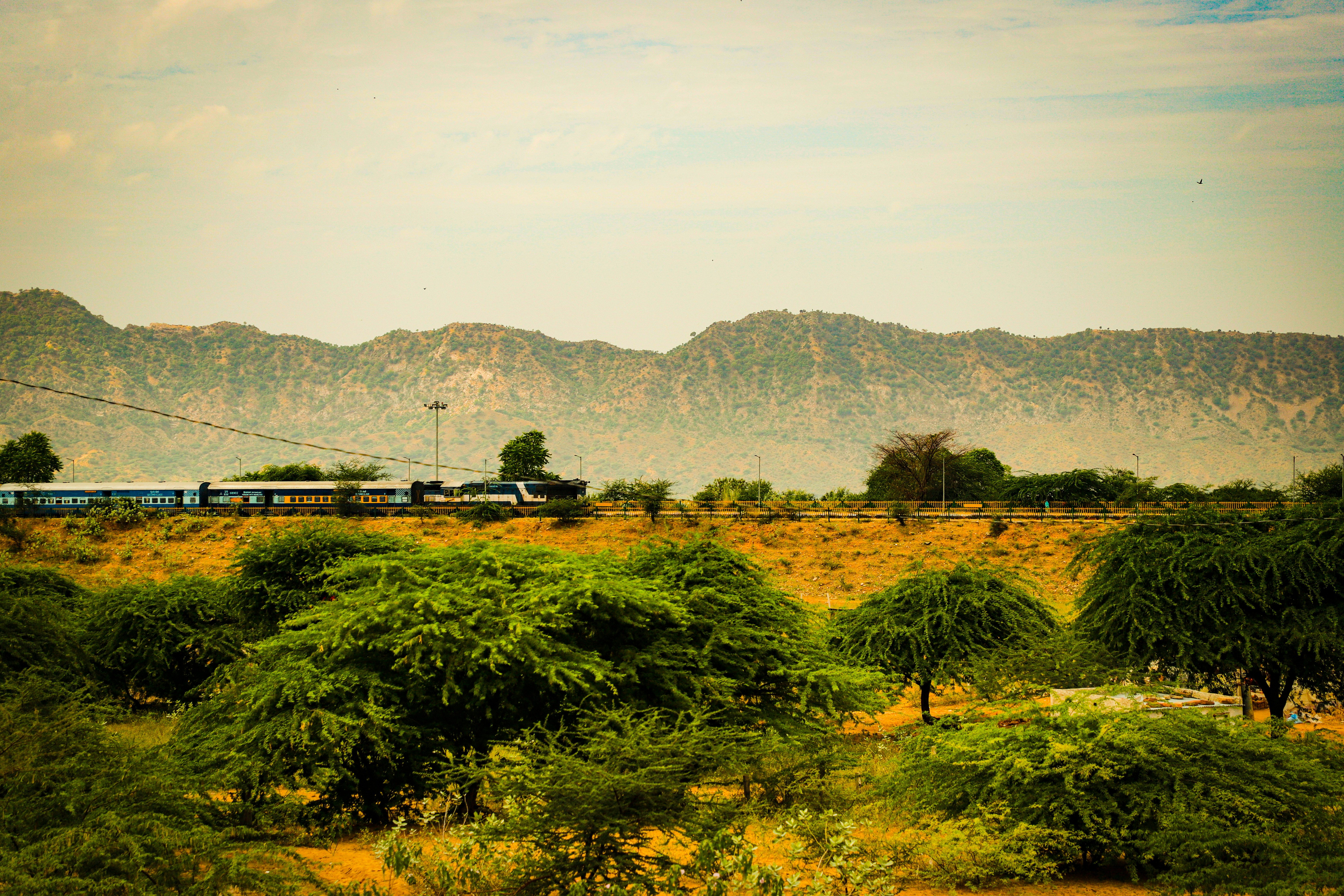 green grass field near mountain during daytime
