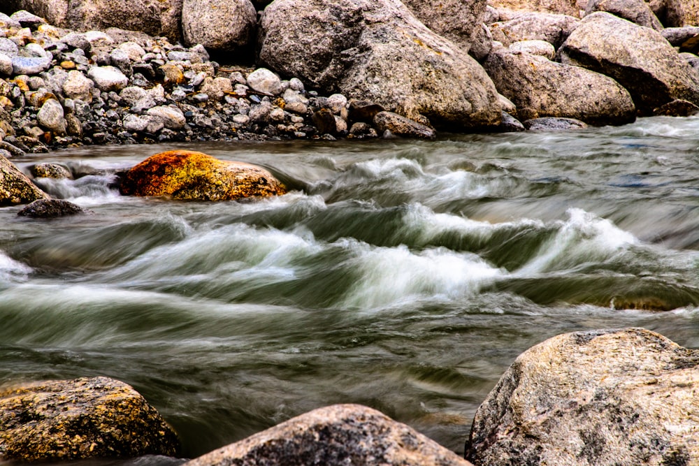 brown rock formation on water