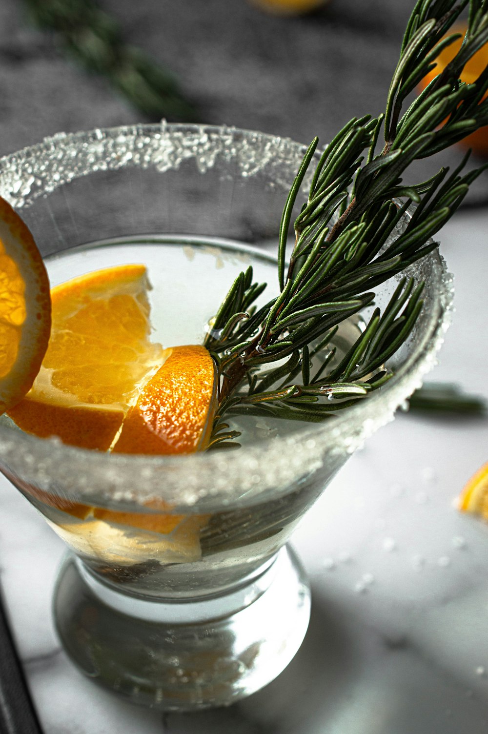 sliced orange fruit on clear glass bowl