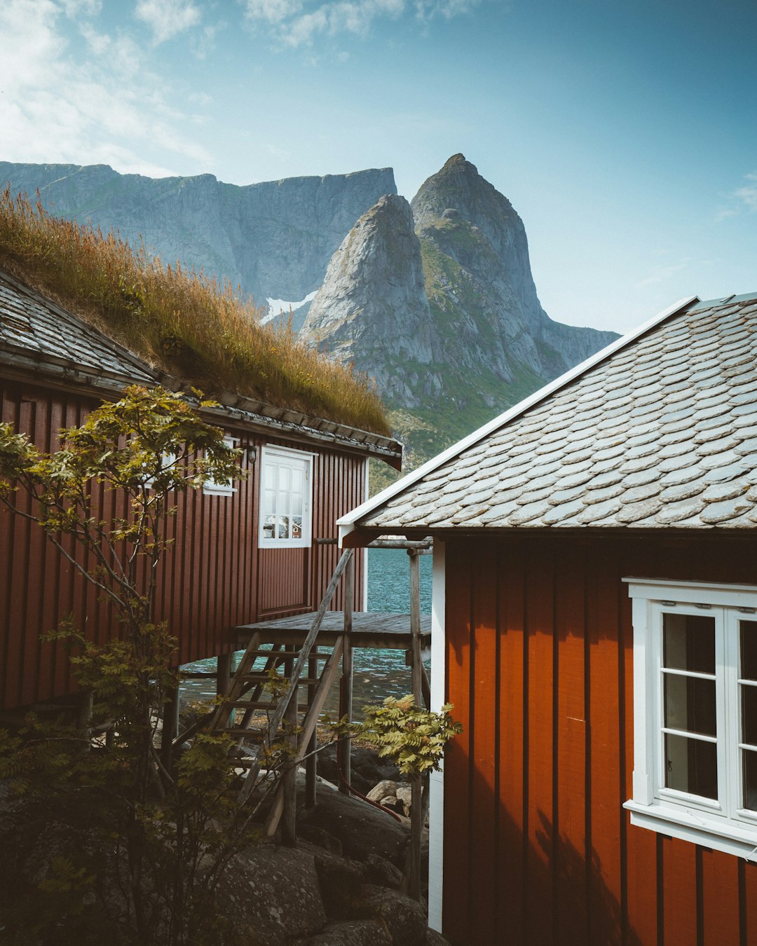 brown wooden house near mountain during daytime