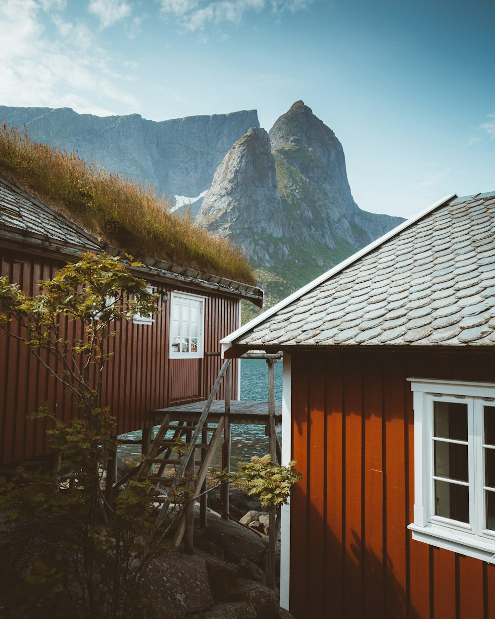 brown wooden house near mountain during daytime