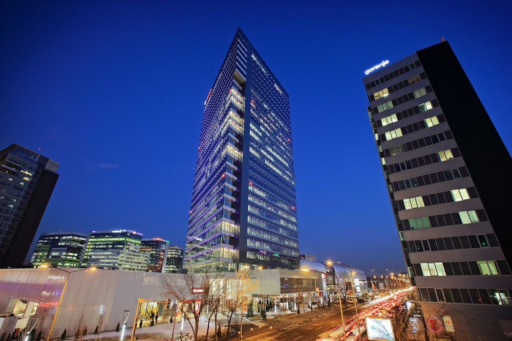 blue and white high rise building during night time