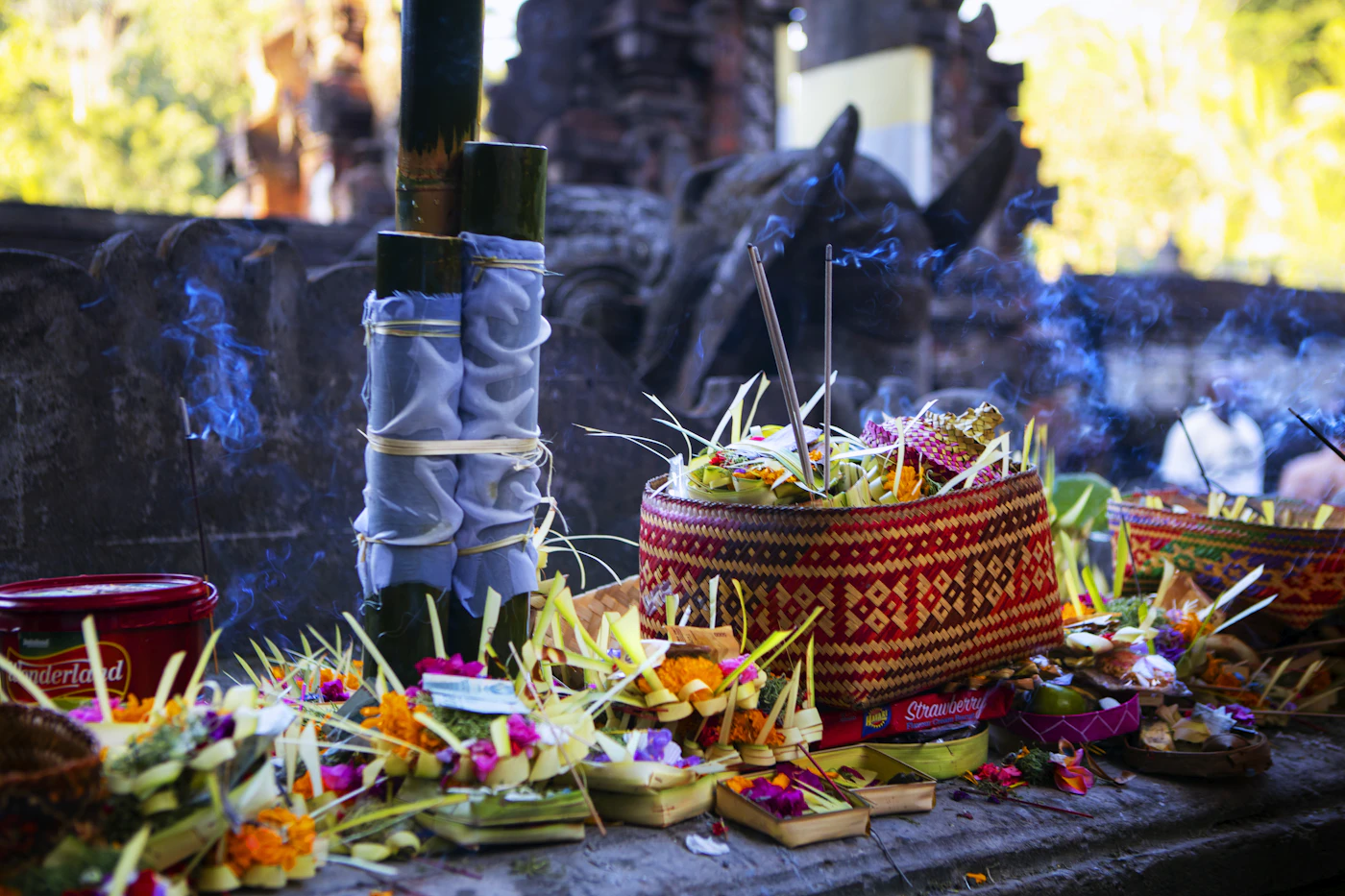 Colourful Balinese offering basket with flowers and fruit at a temple