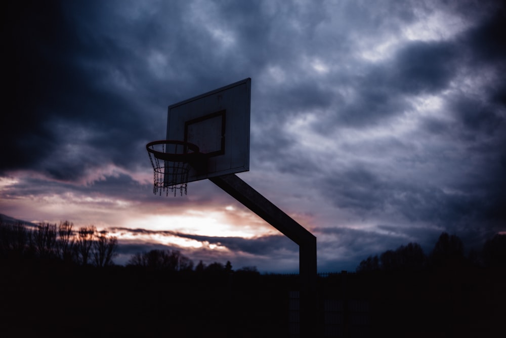 basketball hoop under cloudy sky during daytime