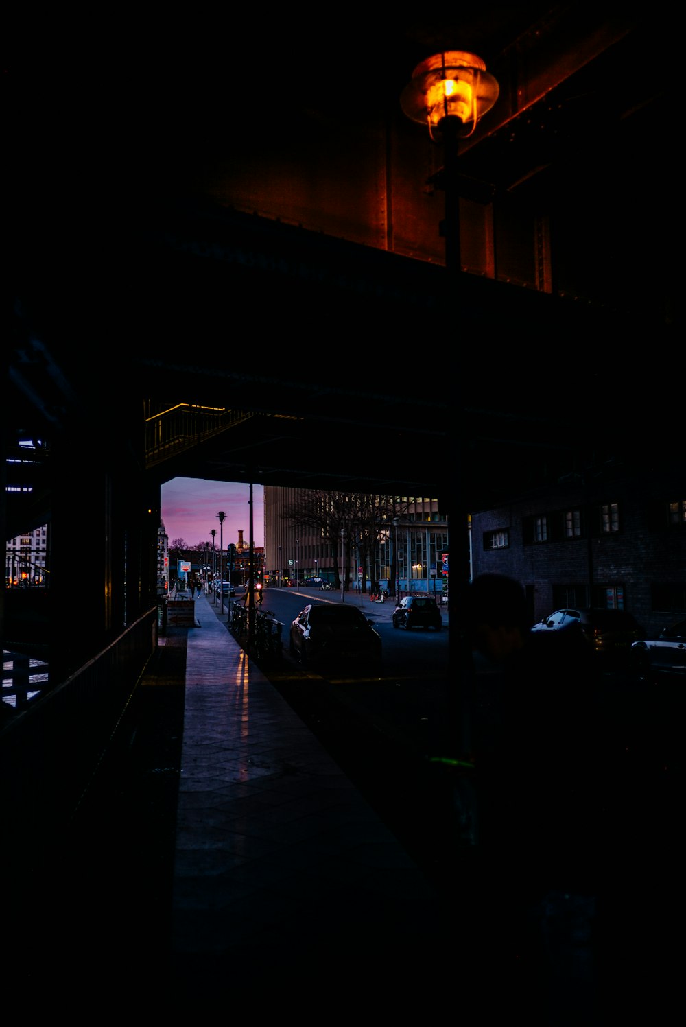 people walking on sidewalk during night time