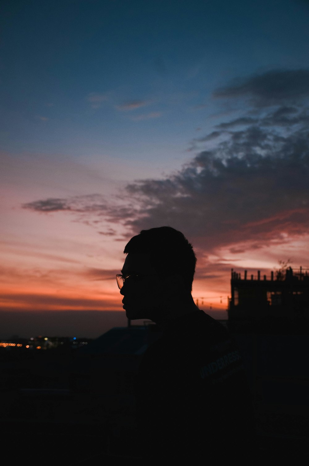 man in black jacket wearing black sunglasses during sunset