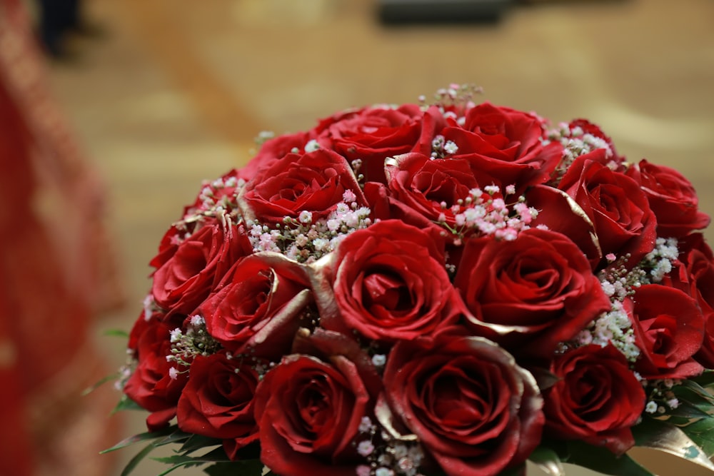 red roses bouquet on brown wooden table