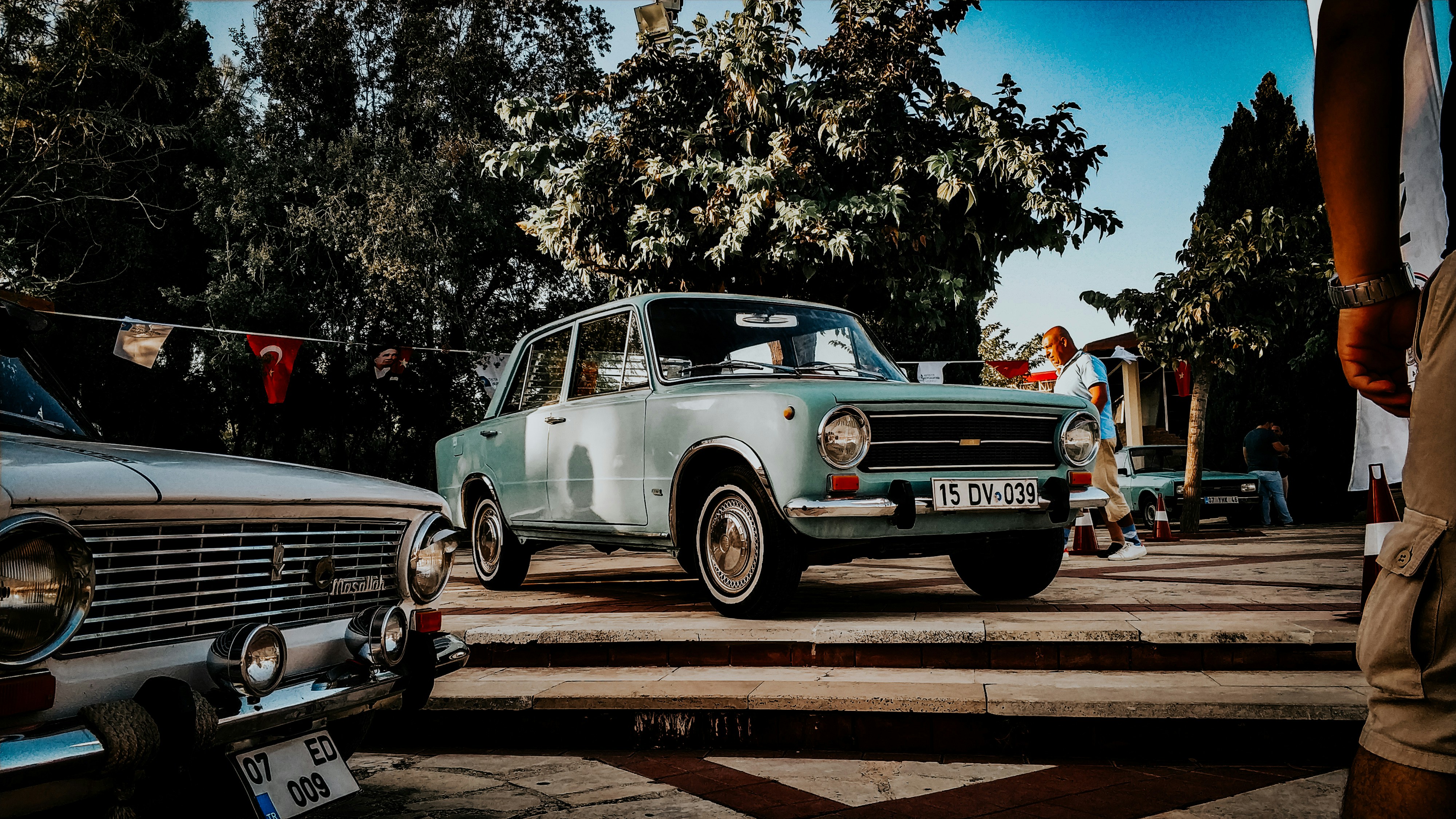 blue and white vintage car on road during daytime
