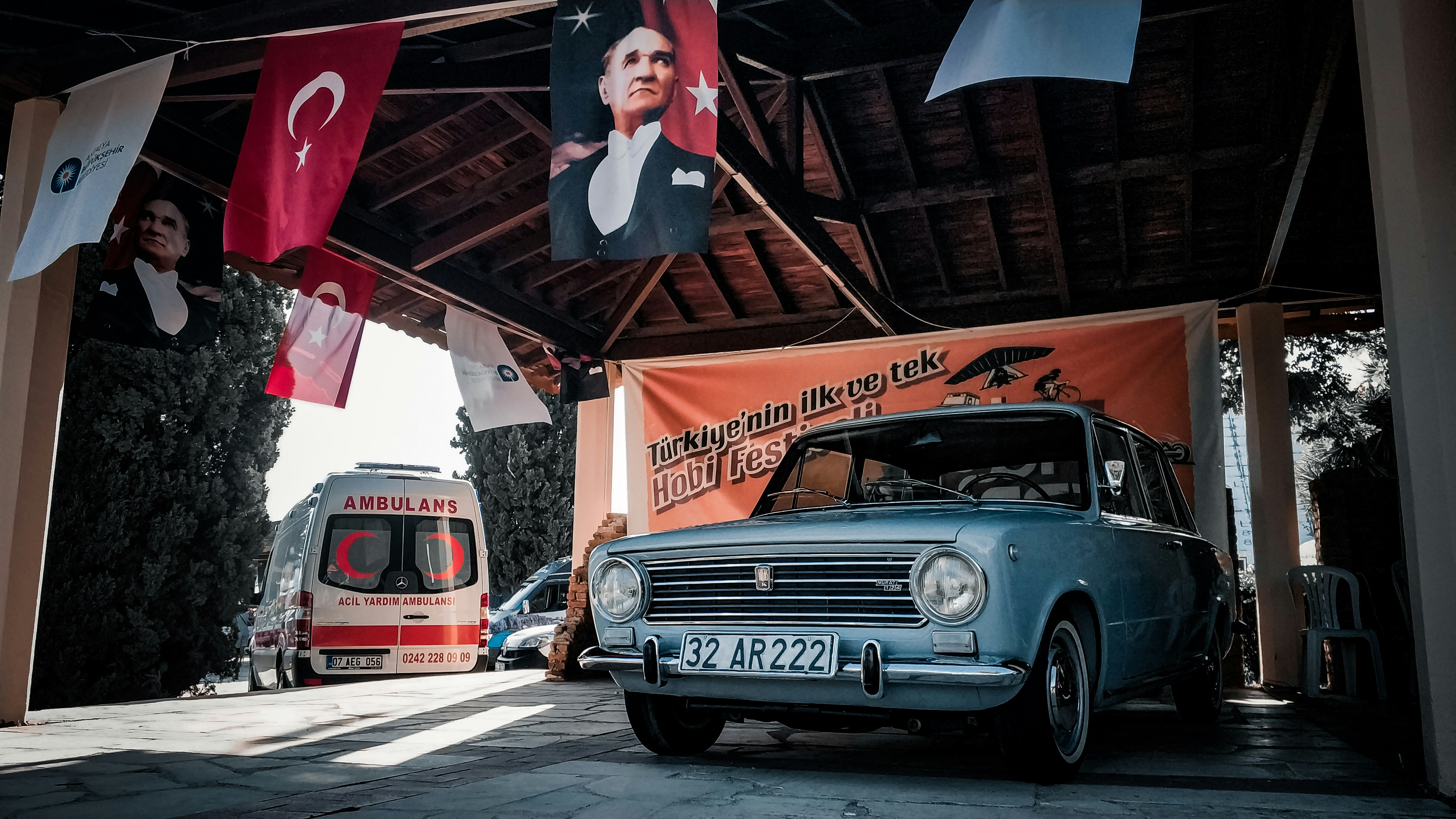 man in black and white striped crew neck t-shirt standing beside red and white car