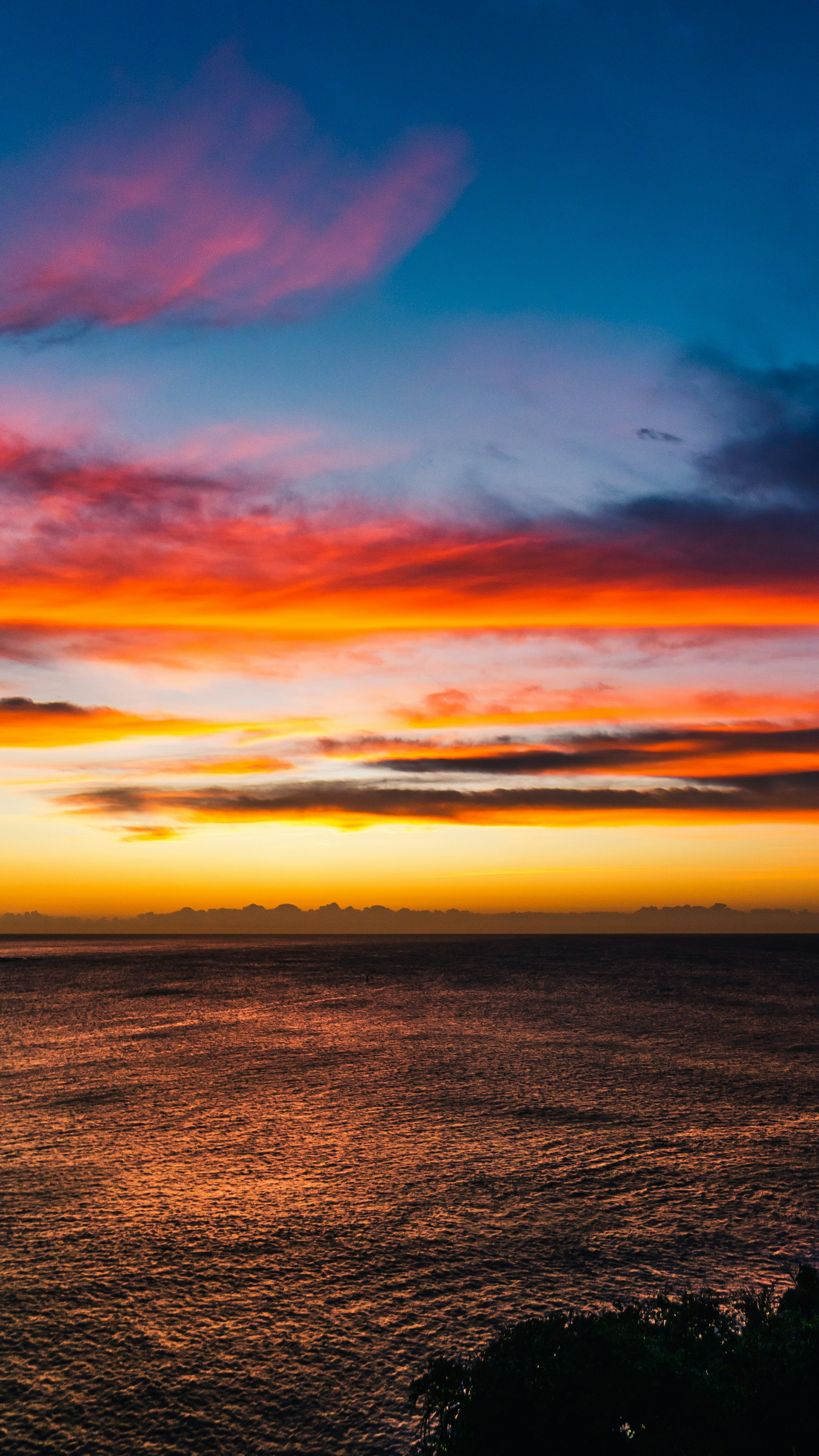 body of water under cloudy sky during sunset