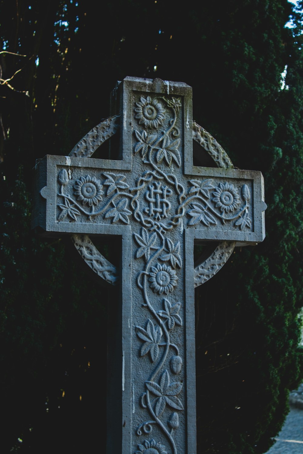 gold cross with cross on top of black surface