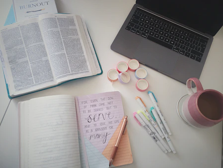A cozy workspace with a water bottle, notebook, and planner neatly arranged.