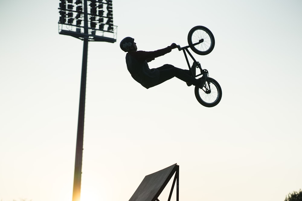 man in black jacket riding on bicycle