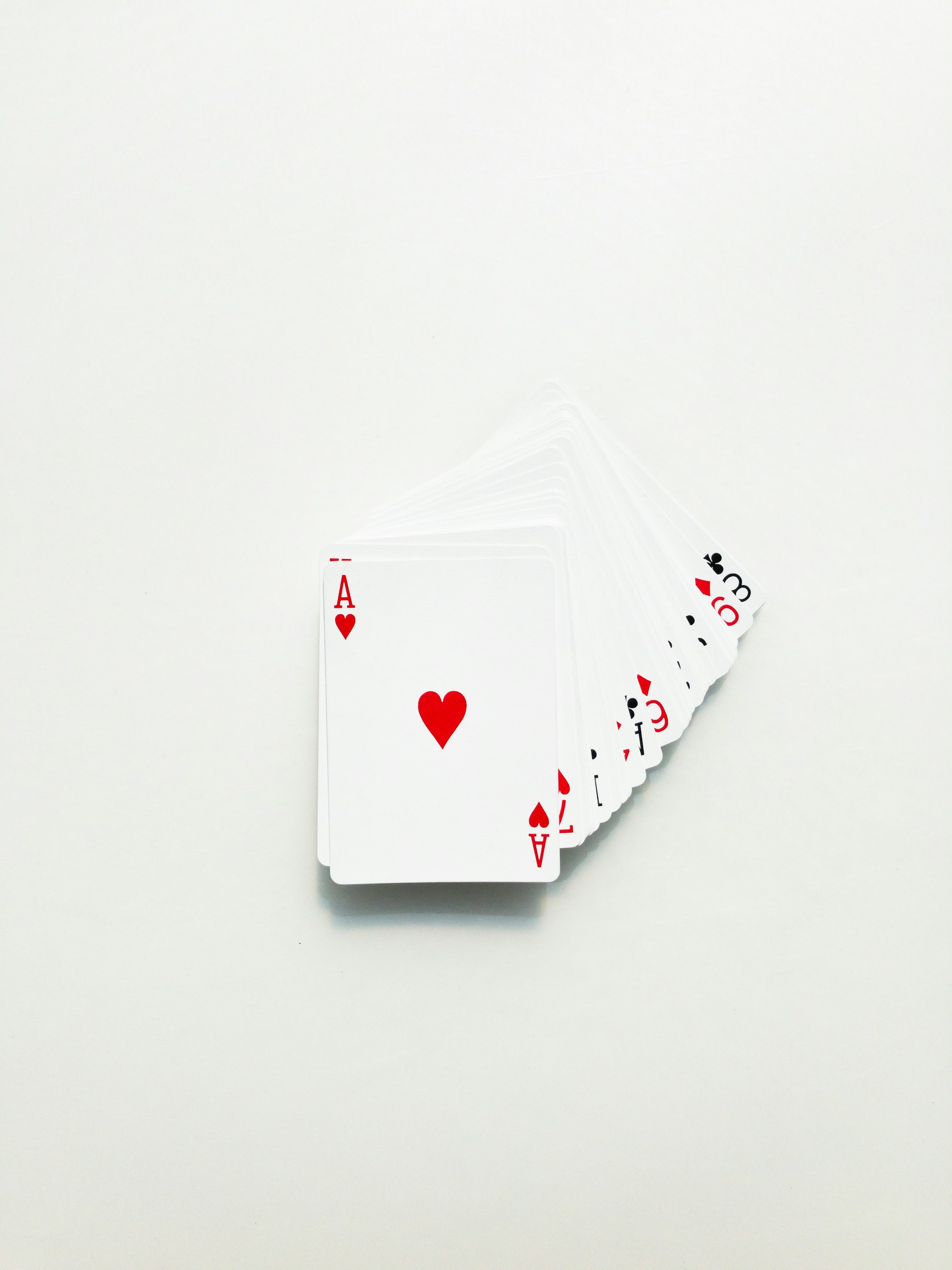 A deck of cards, slightly spread out, with the Ace of Hearts on top.