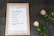 A framed checklist titled 'Publish Blog Post' is displayed on a textured, dark surface. The checklist includes steps such as brainstorming ideas, writing text, taking photos, recording video, setting a publish date, and sharing on social media platforms like Facebook, Twitter, and Pinterest. Next to the frame are two roses, one pink and one white with pink edges, accompanied by green leaves.