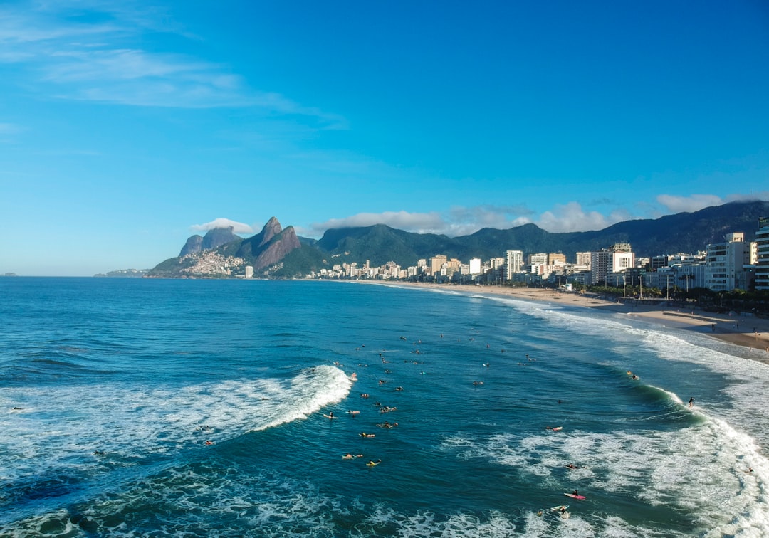 body of water near city buildings under blue sky during daytime