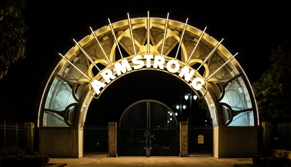 the entrance to a building lit up at night