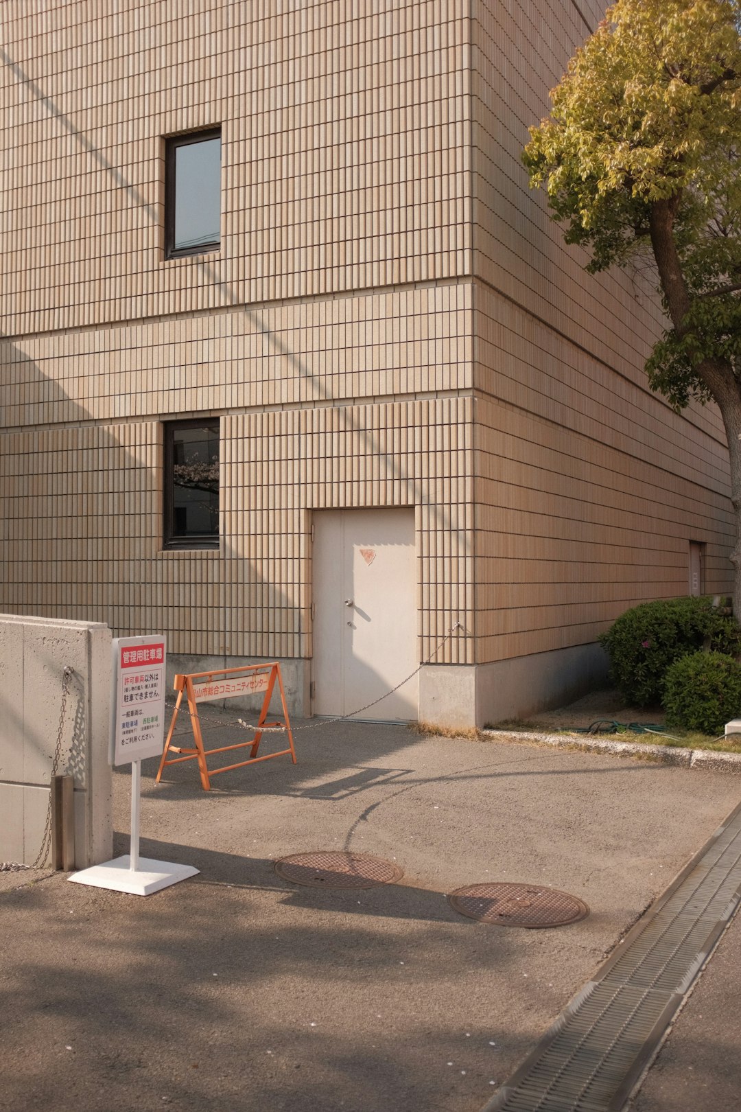 brown brick building with white and red basketball hoop